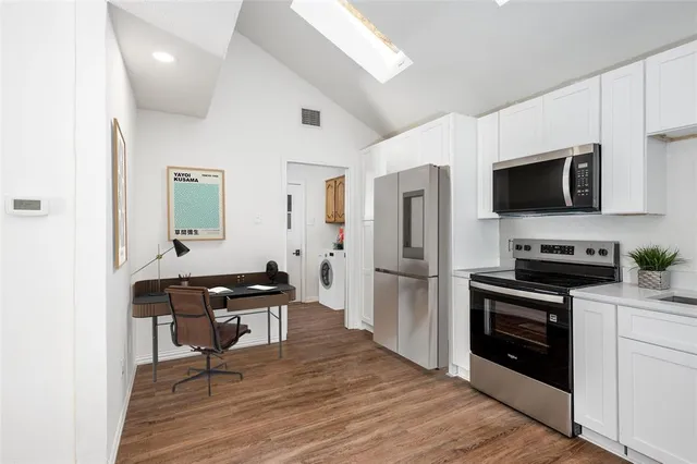 a kitchen with a sink stainless steel appliances and cabinets