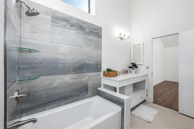 a white bath tub sitting next to a white sink