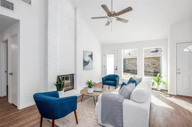 a living room with furniture and a potted plant