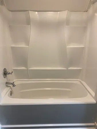 a bathroom with a tub and a shower