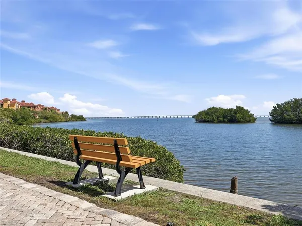 an empty room with wooden floor fireplace and windows