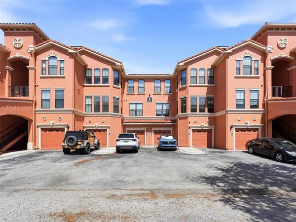 a front view of a house with swimming pool garden and outdoor seating