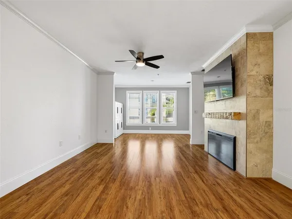 a view of empty room with wooden floor and fireplace
