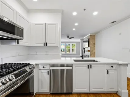 a kitchen with a sink stove and cabinets