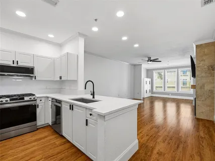 a view of empty room with wooden floor and fireplace