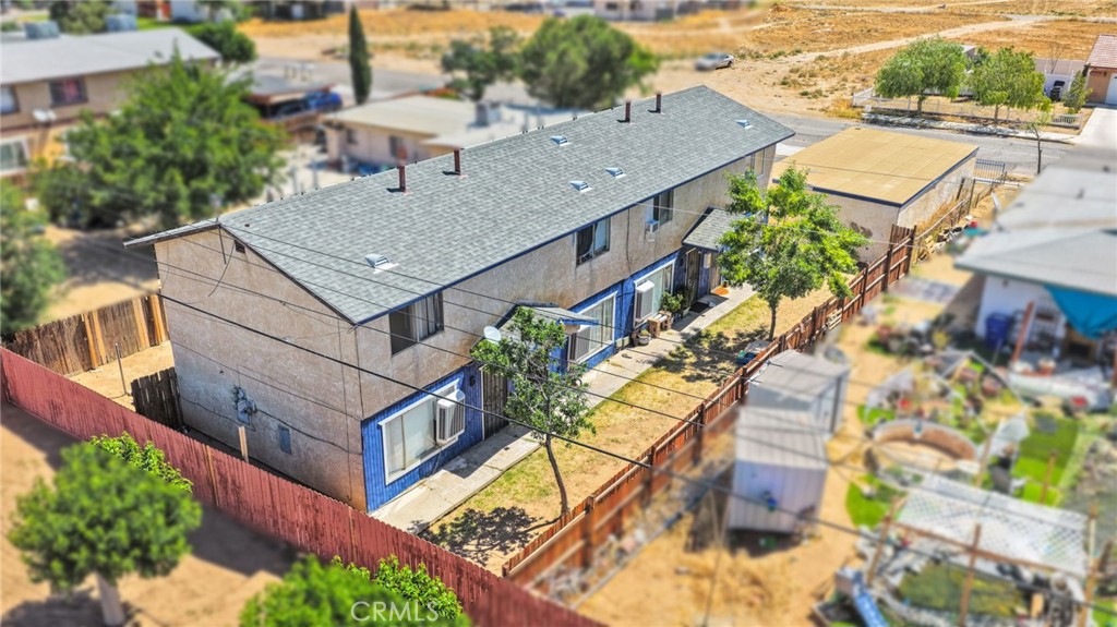 18130 Casaba Road Adelanto, CA 92301 - Photo 1 of 13 an aerial view of a house with a yard and potted plants