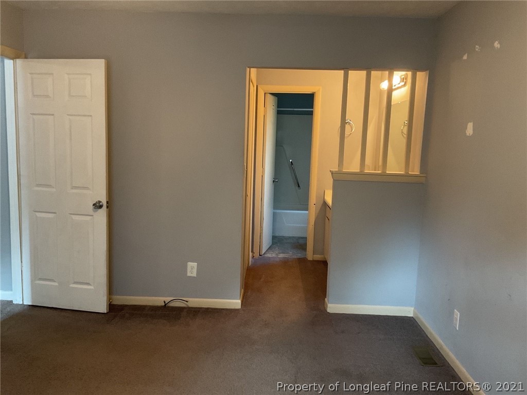 2279 Hackney Loop Fayetteville, NC 28304 - Photo 2 of 11 an empty room with windows and closet