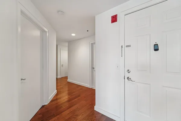 a view of hallway with wooden floor