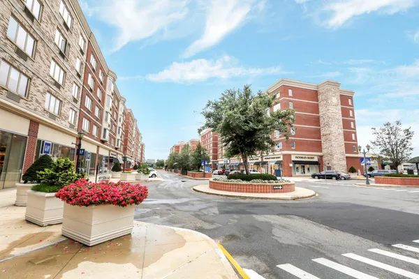 a view of a patio with a table and chairs and potted plants