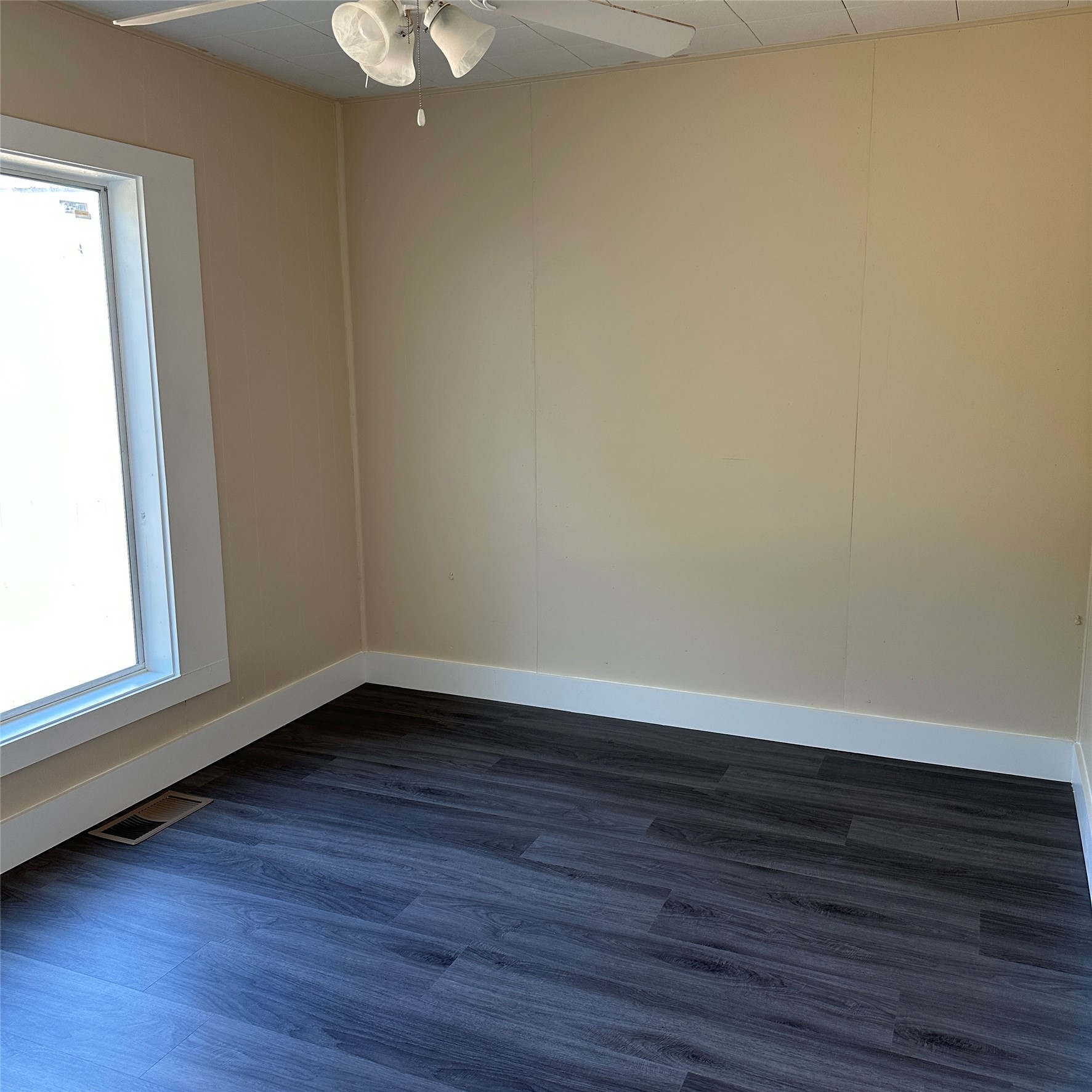 1321 Harris Hill Road San Marcos, TX 78666 - Photo 4 of 11 a view of an empty room with wooden floor and a window