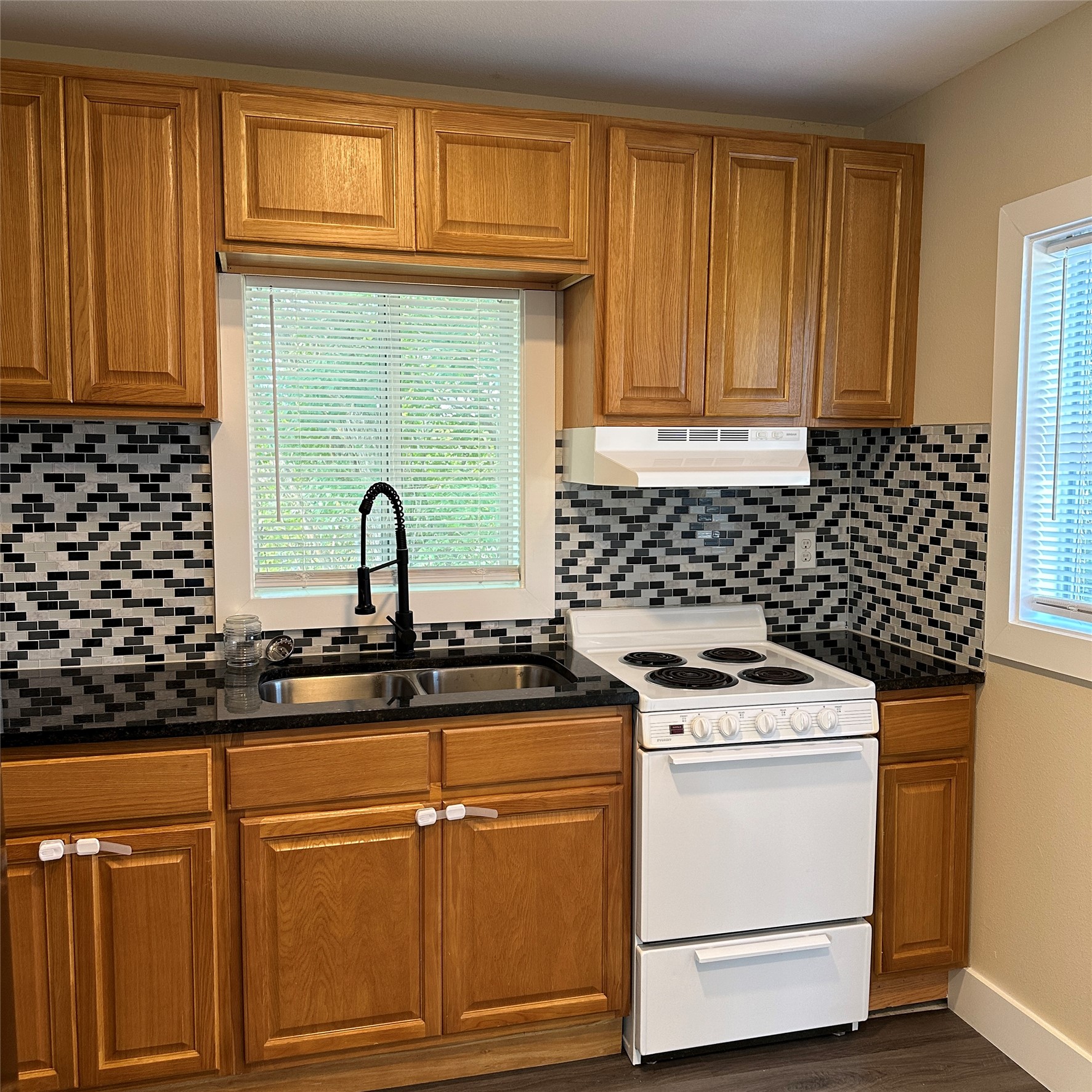 1321 Harris Hill Road San Marcos, TX 78666 - Photo 5 of 11 a view of a kitchen counter space a stove and a window