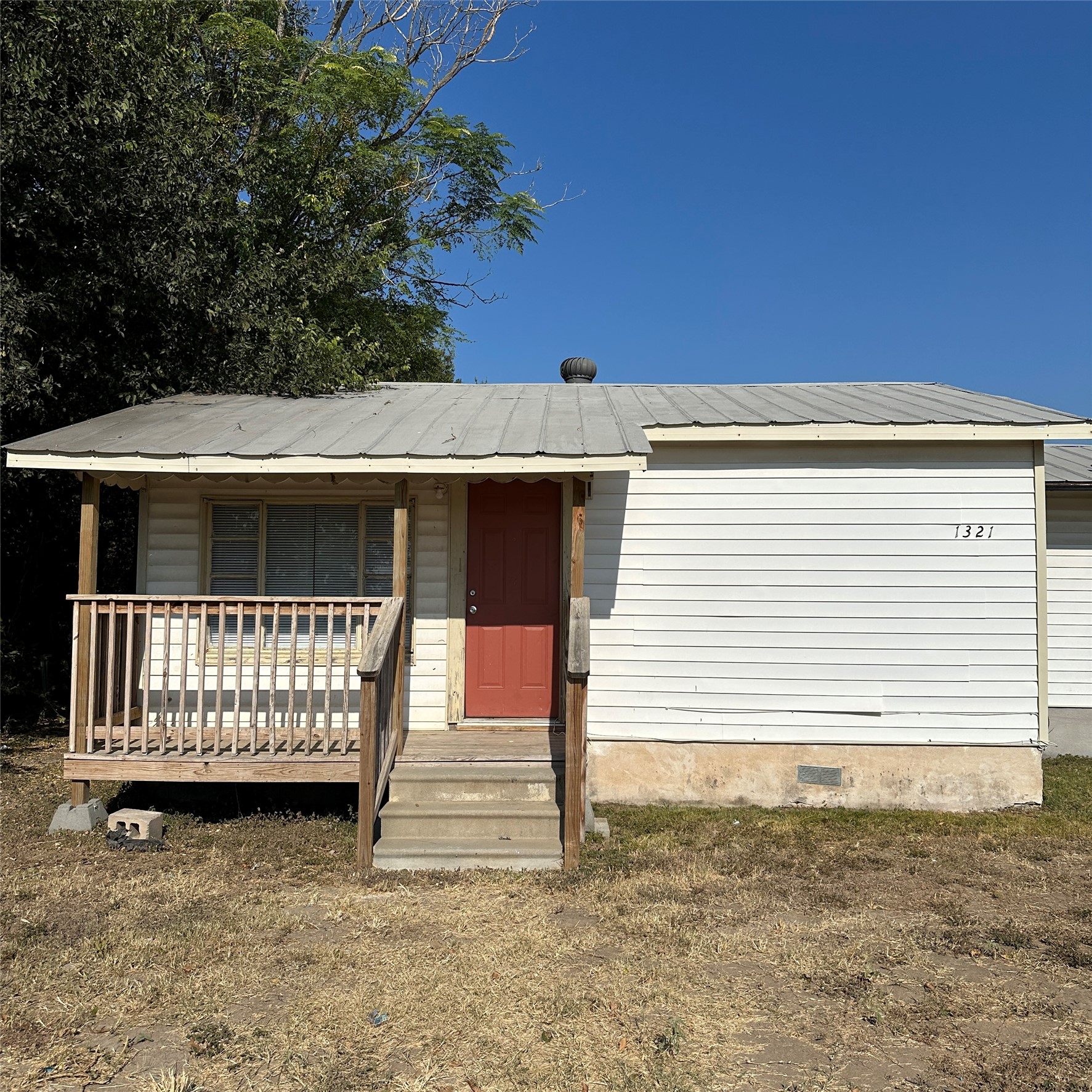 1321 Harris Hill Road San Marcos, TX 78666 - Photo 7 of 11 a view of a house with a wooden deck