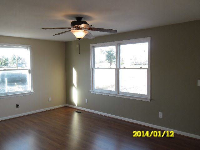 6933 Briery Branch Road Dayton, VA 22821 - Photo 12 of 17 a view of an empty room with wooden floor and a window