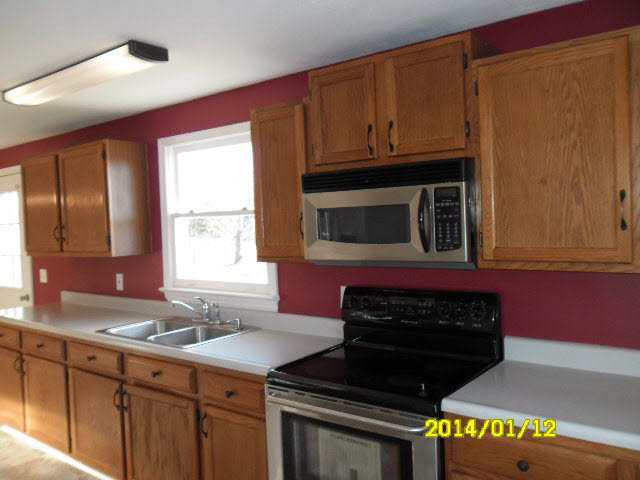 6933 Briery Branch Road Dayton, VA 22821 - Photo 17 of 17 a kitchen with stainless steel appliances granite countertop a stove a microwave and a sink