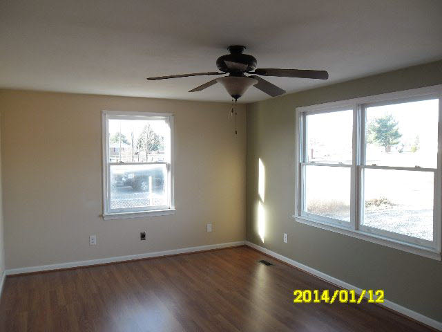 6933 Briery Branch Road Dayton, VA 22821 - Photo 4 of 17 a view of an empty room with wooden floor and a window