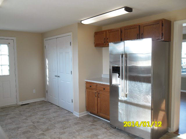 6933 Briery Branch Road Dayton, VA 22821 - Photo 6 of 17 a kitchen with a refrigerator and a sink