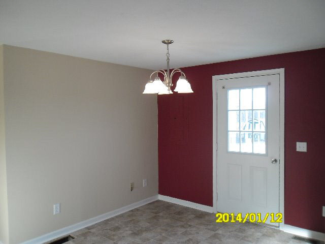 6933 Briery Branch Road Dayton, VA 22821 - Photo 7 of 17 a view of an empty room with window and chandelier fan