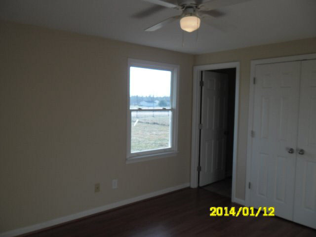 6933 Briery Branch Road Dayton, VA 22821 - Photo 8 of 17 an empty room with windows and ceiling fan