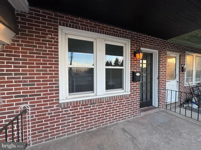 a view of a brick house with large windows