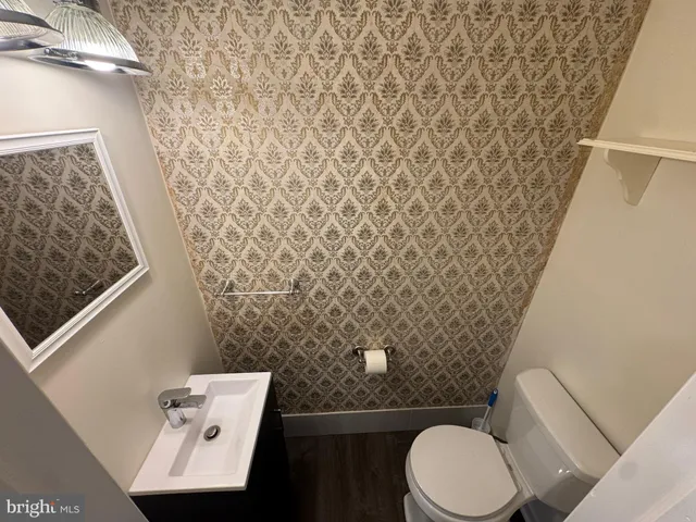 a bathroom with a toilet and a shower curtain