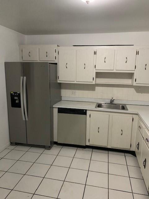 a kitchen with cabinets stainless steel appliances and a sink
