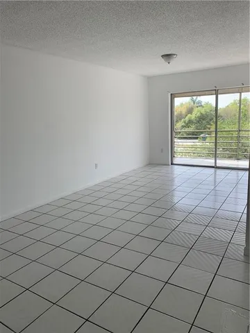 a view of an empty room and a window