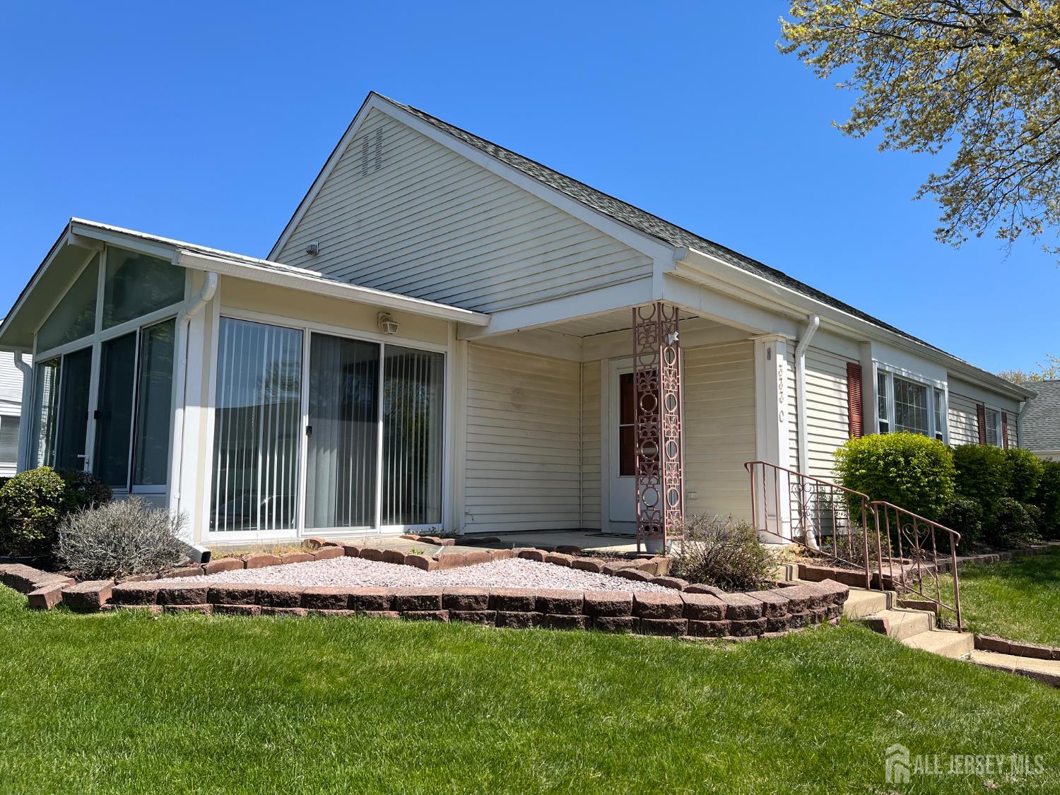 333 Newport Way, Unit C Monroe Township, NJ 08831 - Photo 2 of 17 a front view of a house with a yard and porch