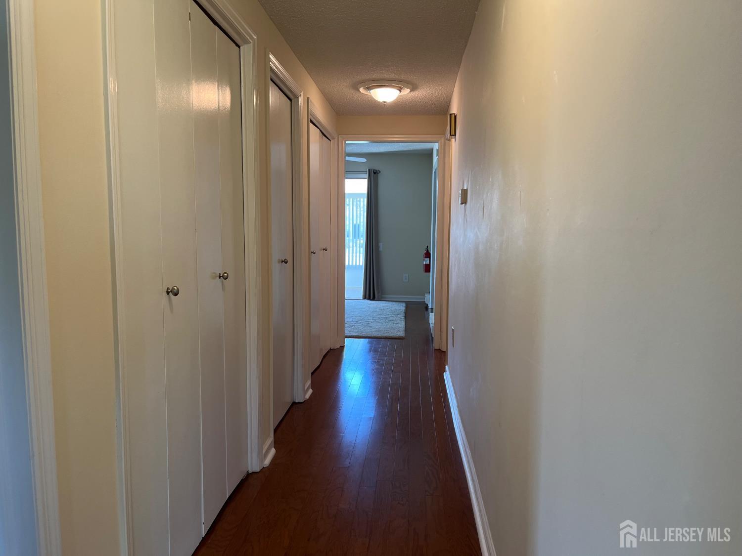 333 Newport Way, Unit C Monroe Township, NJ 08831 - Photo 4 of 17 a view of a hallway with wooden floor