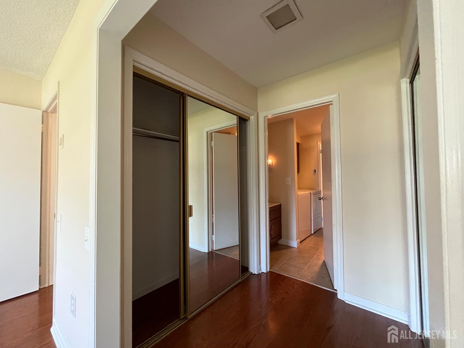 333 Newport Way, Unit C Monroe Township, NJ 08831 - Photo 9 of 17 a view of a hallway with wooden floor