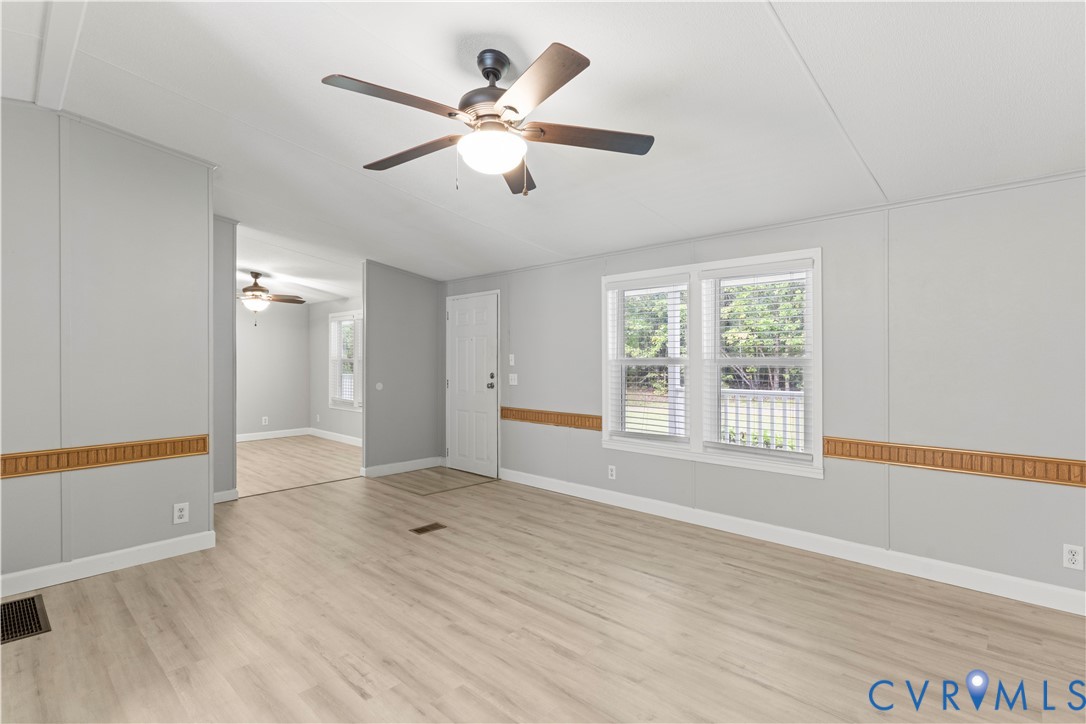 403 Virso Road Meherrin, VA 23954 - Photo 11 of 33 a view of an empty room with wooden floor and a window