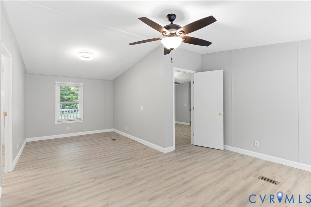 403 Virso Road Meherrin, VA 23954 - Photo 13 of 33 an empty room with wooden floor and windows