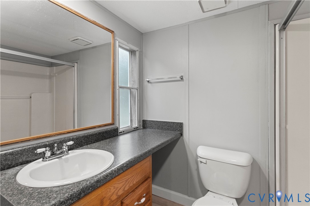 403 Virso Road Meherrin, VA 23954 - Photo 16 of 33 a bathroom with a granite countertop sink and a mirror