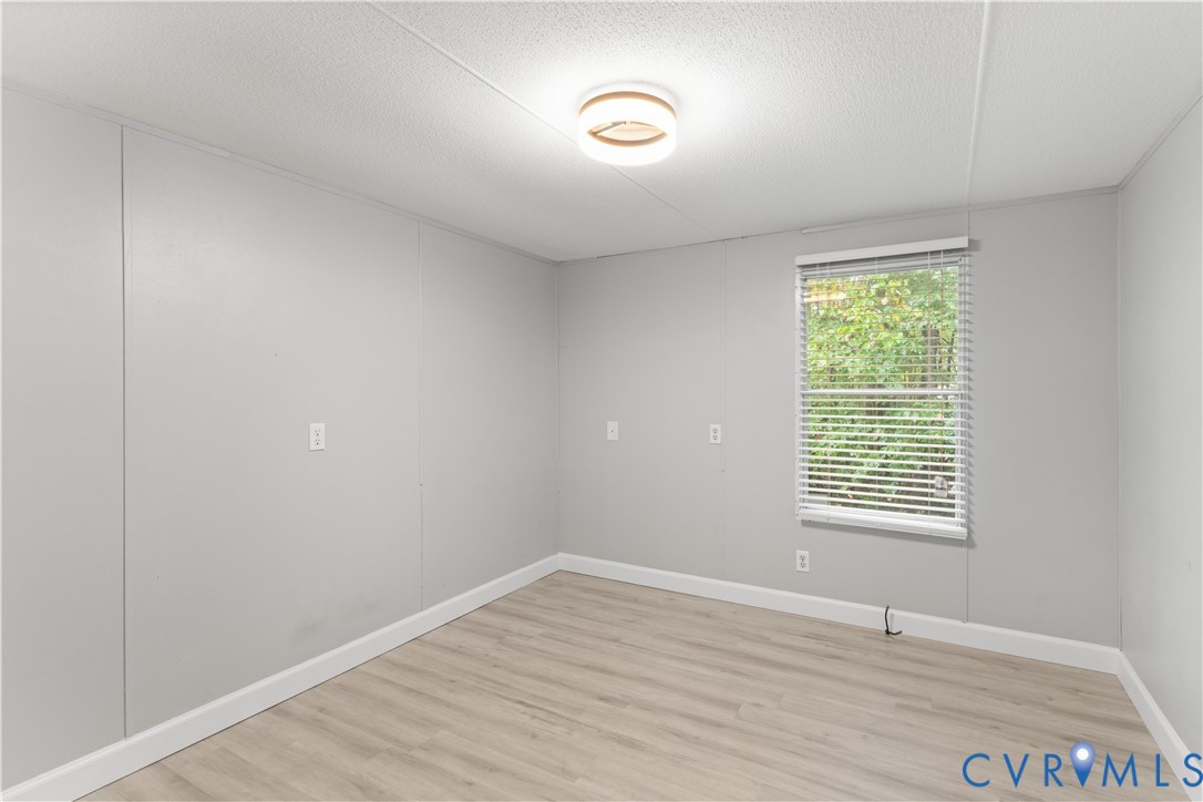 403 Virso Road Meherrin, VA 23954 - Photo 19 of 33 a view of an empty room with wooden floor and a window