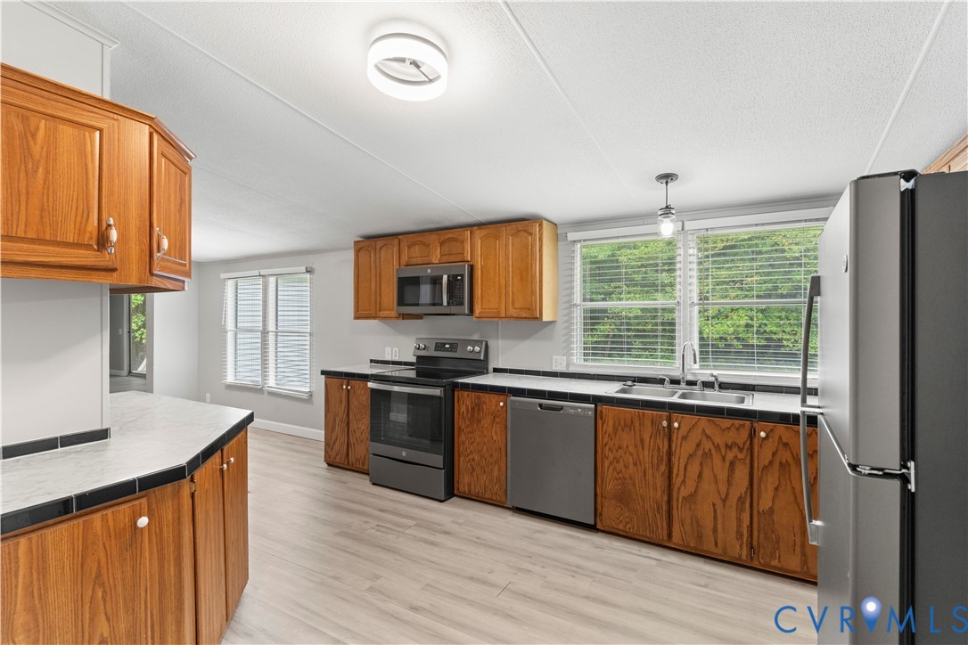 403 Virso Road Meherrin, VA 23954 - Photo 2 of 33 a kitchen with stainless steel appliances granite countertop a stove a sink dishwasher and a refrigerator