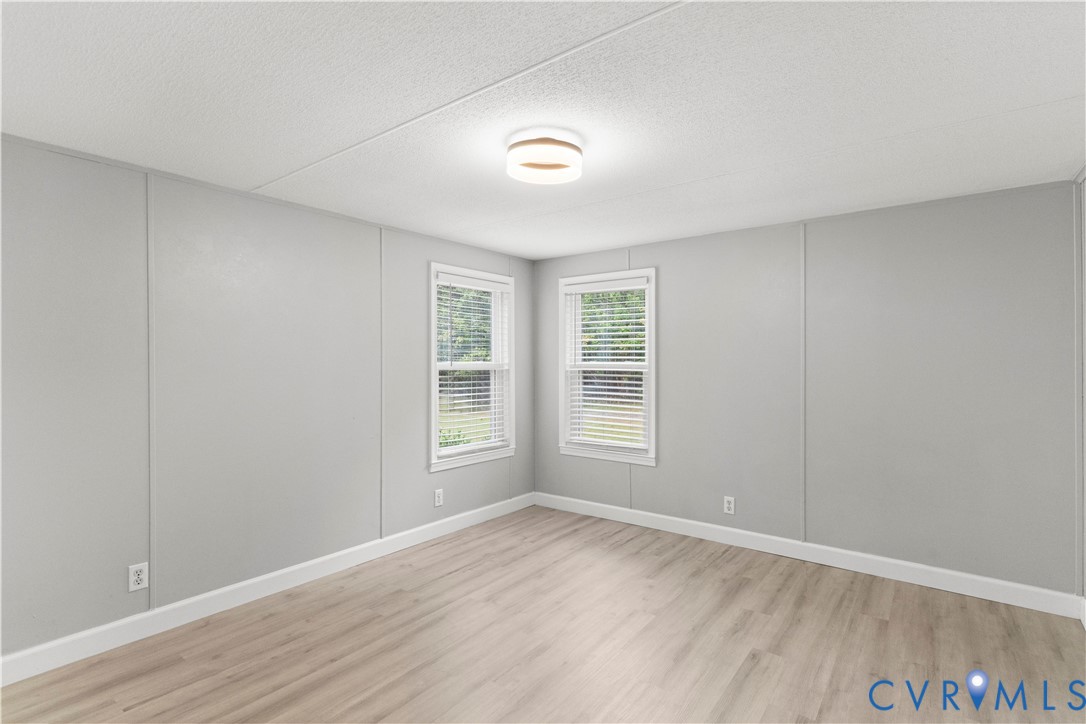403 Virso Road Meherrin, VA 23954 - Photo 23 of 33 a view of empty room with wooden floor and fan