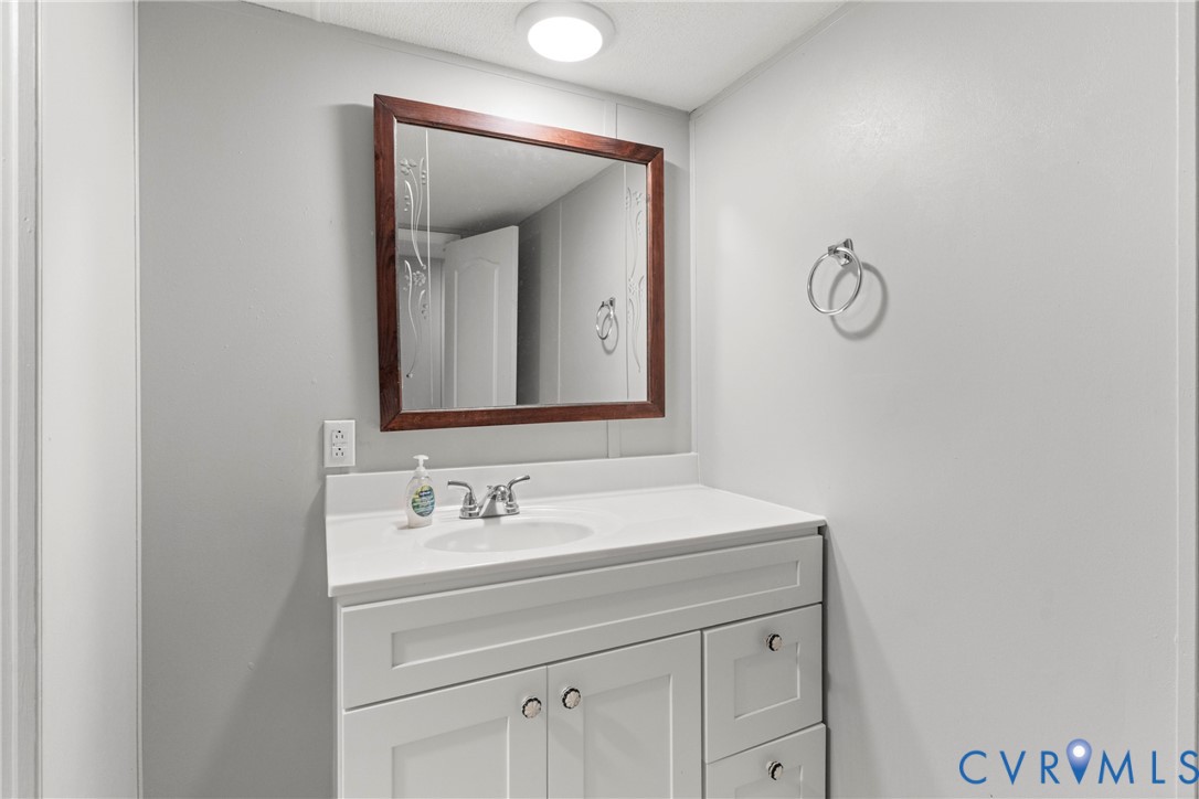 403 Virso Road Meherrin, VA 23954 - Photo 25 of 33 a bathroom with a sink vanity and a mirror