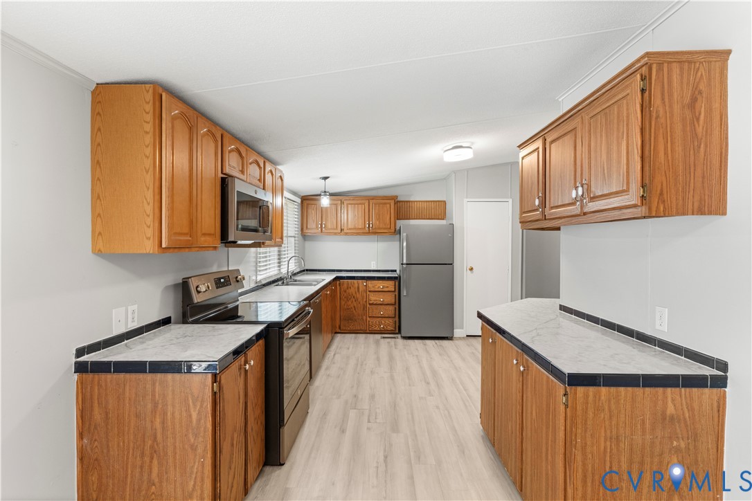 403 Virso Road Meherrin, VA 23954 - Photo 4 of 33 a kitchen with stainless steel appliances granite countertop a sink stove and refrigerator