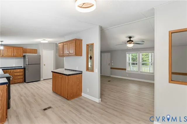 a kitchen with stainless steel appliances granite countertop a refrigerator and a stove top oven