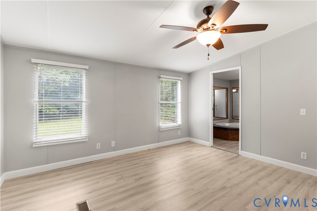 403 Virso Road Meherrin, VA 23954 - Photo 9 of 33 wooden floor in an empty room with a window