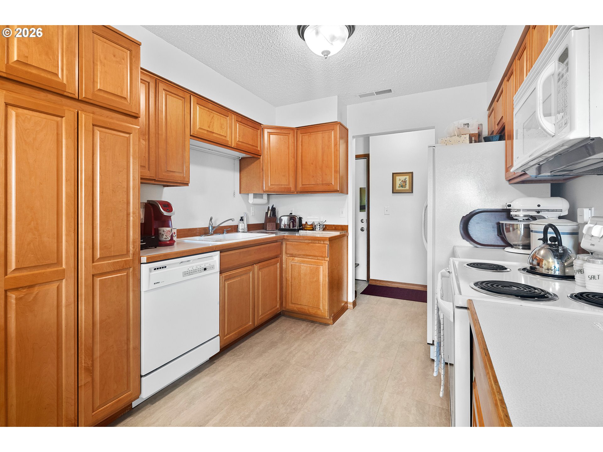 1900 Northwest Carden Avenue, Unit 22 Pendleton, OR 97801 - Photo 6 of 29 a kitchen with a sink a stove cabinets and a window