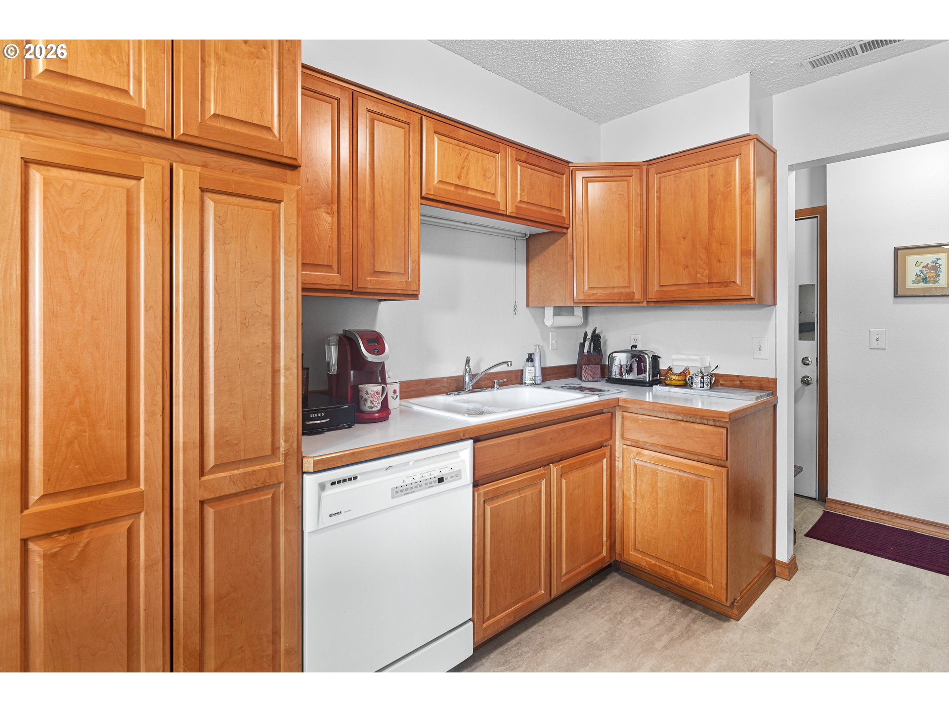 1900 Northwest Carden Avenue, Unit 22 Pendleton, OR 97801 - Photo 7 of 29 a kitchen with stainless steel appliances granite countertop a refrigerator a sink dishwasher and cabinets with wooden floor