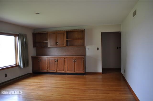 727 West Walnut Road Freeport, IL 61032 - Photo 7 of 11 a view of a room with wooden floor and window