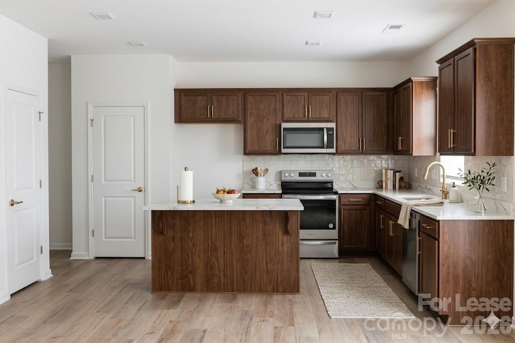 1215 Nesters Store Place Southwest Concord, NC 28027 - Photo 4 of 16 a kitchen with a sink cabinets and stainless steel appliances