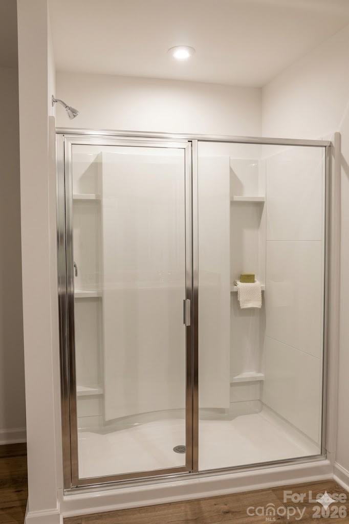 1215 Nesters Store Place Southwest Concord, NC 28027 - Photo 9 of 16 a bathroom with a glass shower door