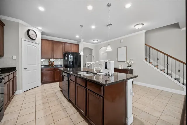 a kitchen with stainless steel appliances granite countertop a sink counter space cabinets and a view of counter top space
