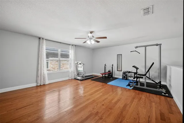 a view of a room with gym equipment and windows