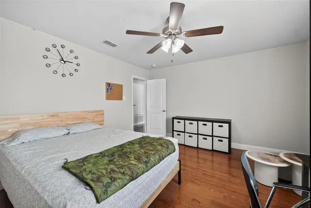 a bedroom with a bed chandelier and a window