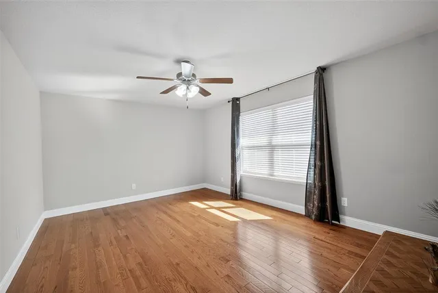 wooden floor in an empty room with a window