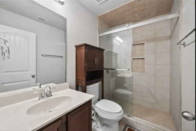 a bathroom with a sink toilet and shower