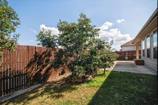 an aerial view of multiple houses with yard